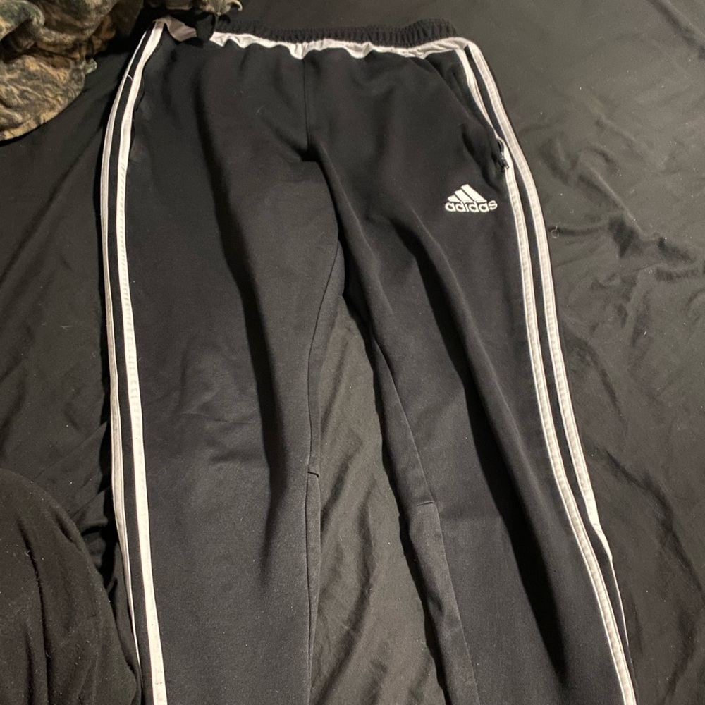 Black with white stripes adidas joggers . size Med